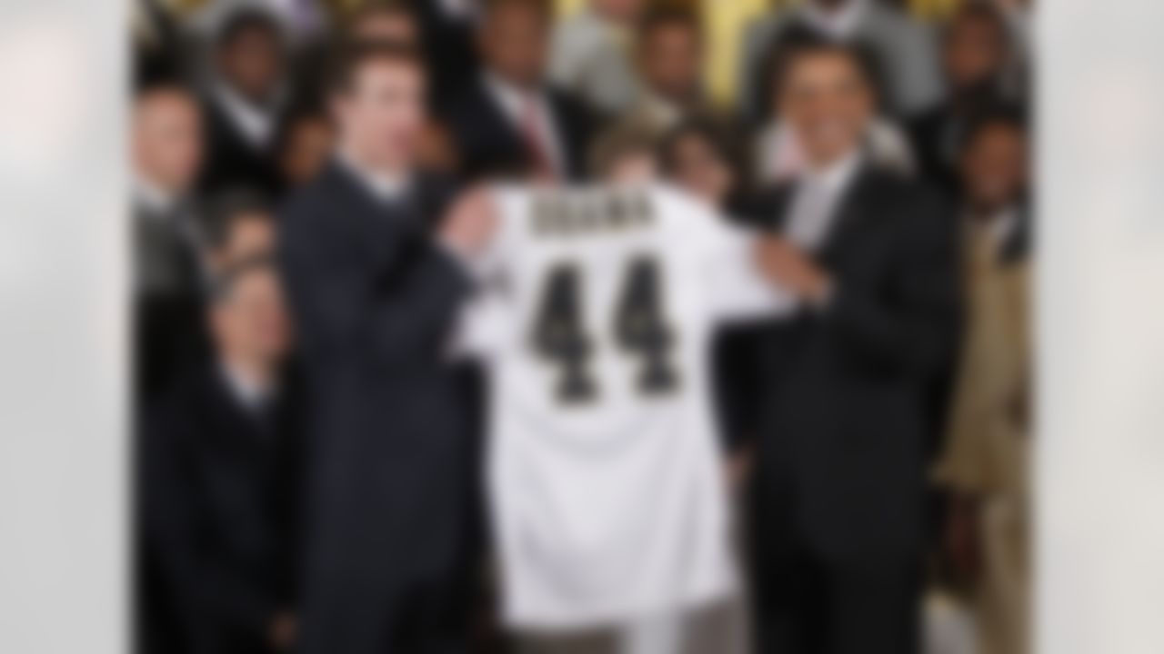 New Orleans Saints football quarterback Drew Brees and President Barack Obama hold a personalized team jersey, Monday, Aug. 9, 2010, in the East Room of the White House in Washington, as he honored the 2009 NFL Super Bowl NFL Football Champions New Orleans Saints. (AP Photo/Charles Dharapak)