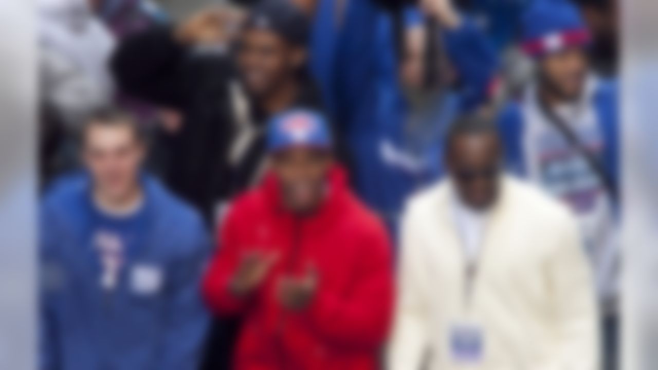 New York Giants kicker Lawrence Tynes, left, and wide receivers Victor Cruz, center, and Hakeem Nicks celebrate during the team's NFL football Super Bowl parade in New York, Tuesday, Feb. 7, 2012. The Giants returned from their Super Bowl win to a celebration the likes that only New York can throw: a ticker-tape parade in the Canyon of Heroes on Broadway, where the city has honored stars for almost a century. (AP Photo/Mark Lennihan)