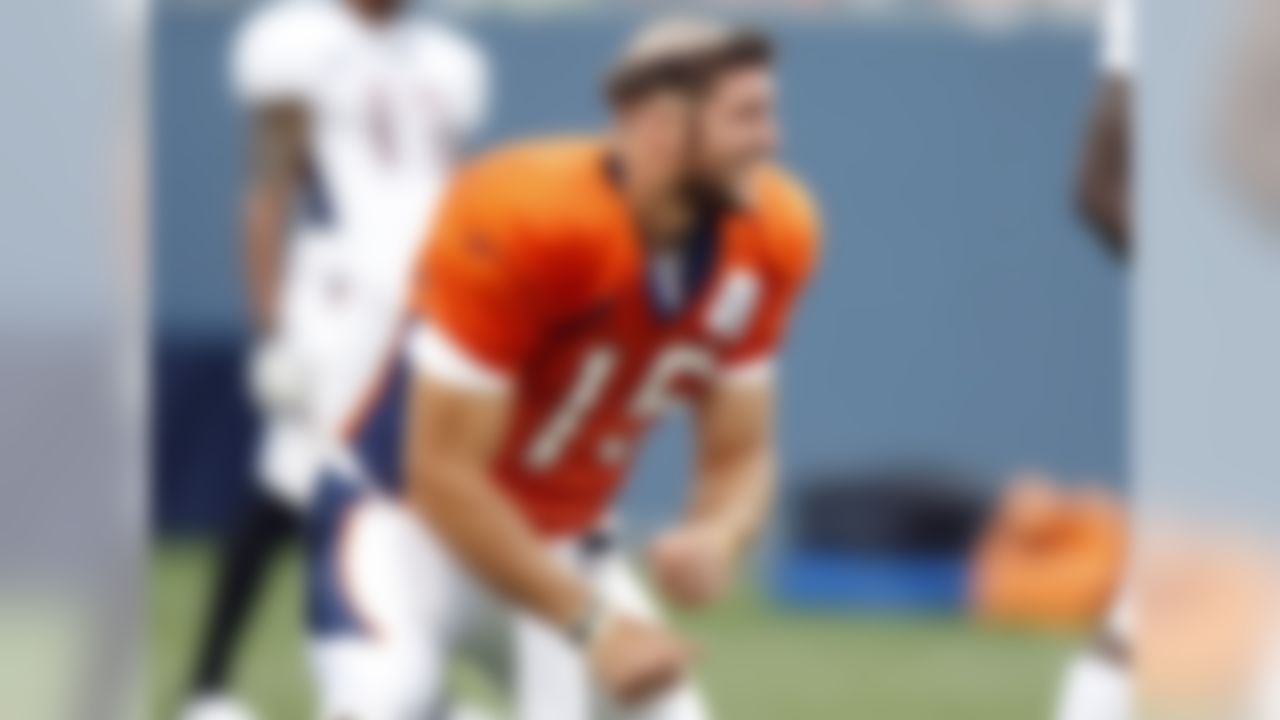 Tim Tebow sports a new hairdo during warmups after veterans gave haircuts to rookies prior to a Denver Broncos practice at Invesco Field August 7, 2010 in Denver,CO.