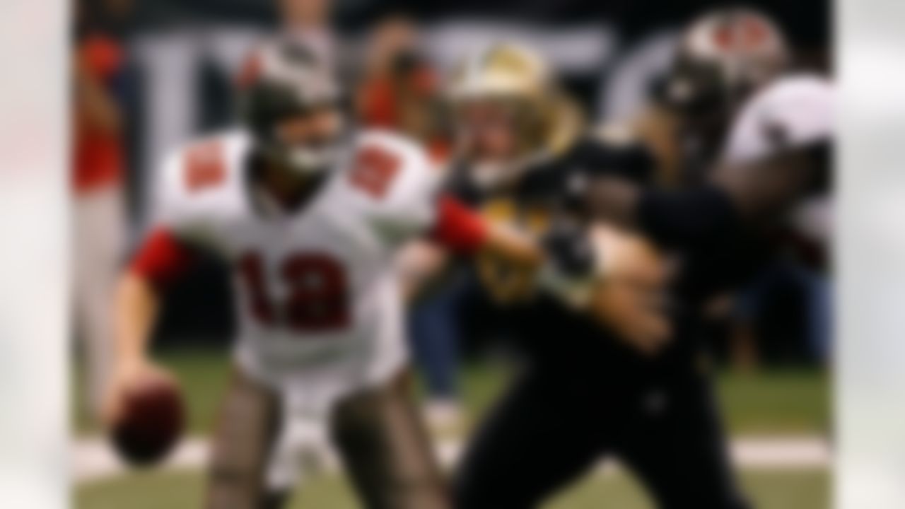NEW ORLEANS - DECEMBER 02: Quarterback Luke McCown #12 of the Tampa Bay Buccaneers tries to avoid a tackle by Brian Young #66 of the New Orleans Saints on December 2, 2007 at the Louisiana Superdome in New Orleans, Louisiana. (Photo by Chris Graythen/Getty Images)