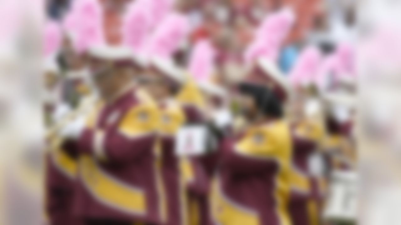 The Washington Redskins Marching Band wear pink feathers on their hats as they performs prior to the game against the San Francisco 49ers at FedEx Field in Landover, Maryland on Sunday, October 15, 2017.