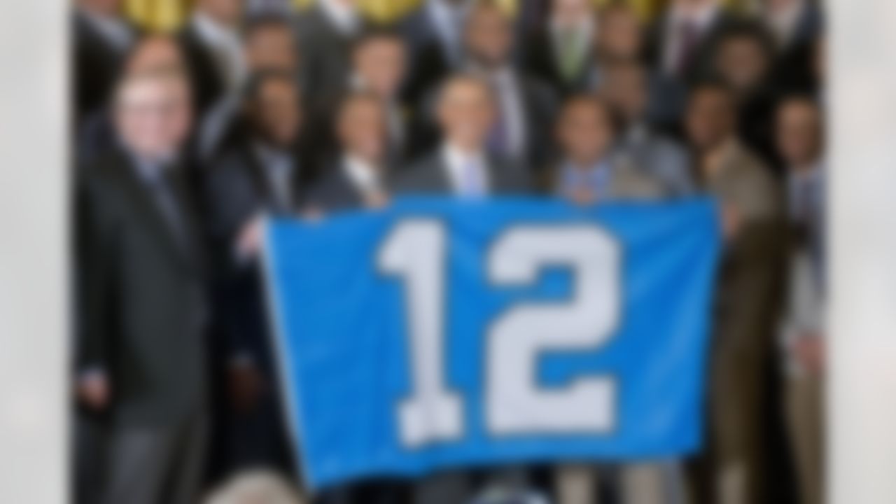 President Barack Obama holds up a banner with a "12" as he welcomes the NFL Super Bowl champion Seattle Seahawks football team to the East Room of the White House in Washington, Wednesday, May 21, 2014. The Seahawks defeated the Denver Broncos in Super Bowl XLVIII. (Pablo Martinez Monsivais/Associated Press)