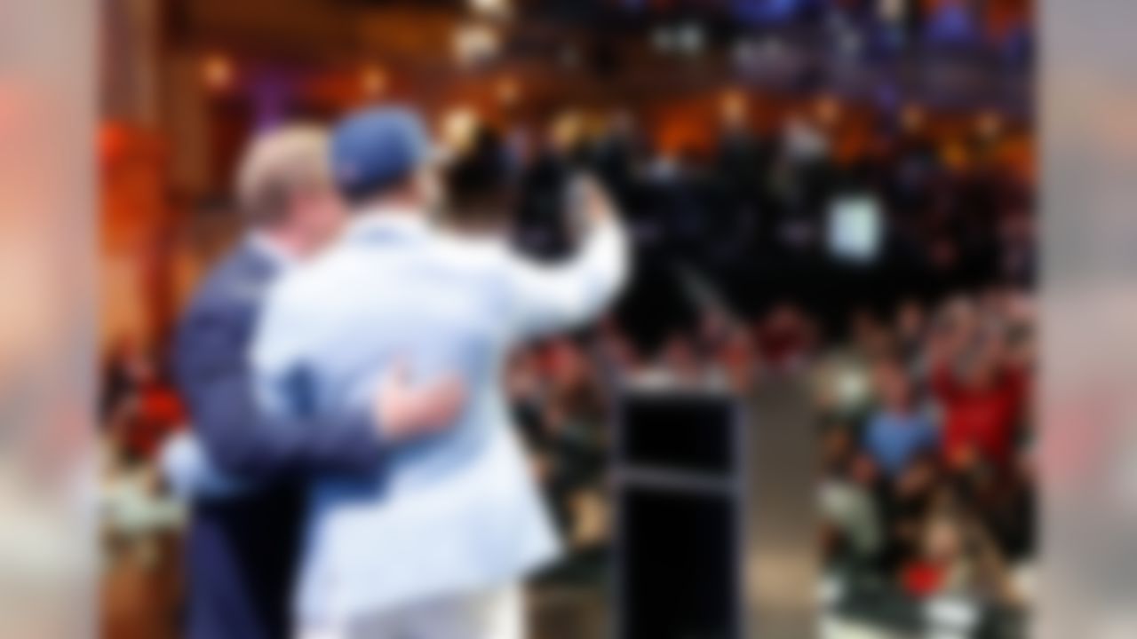 Ohio State�s Ezekiel Elliott poses for photos on stage with NFL Commissioner Roger Goodell after being selected by the Dallas Cowboys during the 2016 NFL Draft at the Auditorium Theatre on Thursday, April 28, 2016 in Chicago. (Ben Liebenberg/NFL)