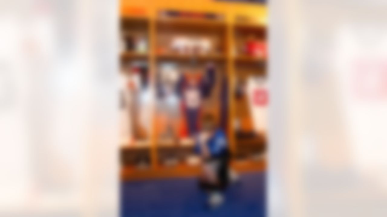 Jan. 28, 2012; Indianapolis, IN, USA; A young football fan poses before a life size locker room display of Tim Tebow (not pictured) from the NFL Experience at the Indiana Convention Center. Mandatory credit: Michael Hickey-US PRESSWIRE