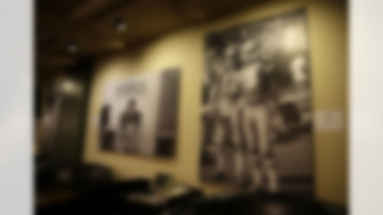 In this photo taken Tuesday, Dec. 17, 2013, large photographs of Joe Montana, John Brodie and Gene Washington hang on a wall at The Stadium Club at Candlestick Park in San Francisco. The San Francisco 49ers are about to play their last NFL football game at the stadium they have called home since 1971. Candlestick Park was also the home of the San Francisco Giants from 1960-1999. (AP Photo/Eric Risberg)
