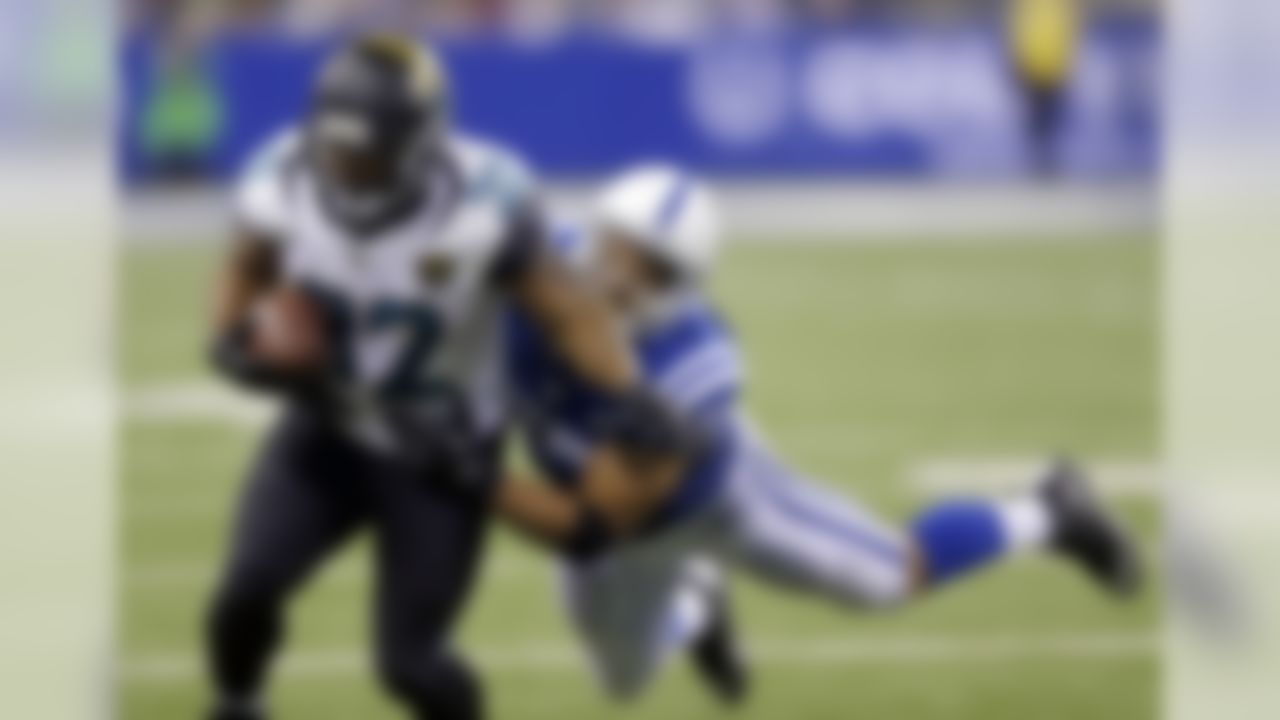 Jacksonville Jaguars' Maurice Jones-Drew (32) is tackled by Indianapolis Colts' Josh McNary (57) during the second half of an NFL football game on Sunday, Dec. 29, 2013, in Indianapolis. (AP Photo/Michael Conroy)