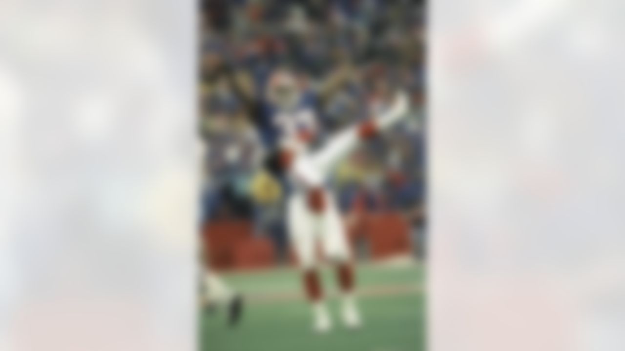 Buffalo Bills cornerback Nate Odoms gets a lift from teammate Henry Jones after intercepting a pass by Warren Moon of the Houston Oilers during the overtime period to set up Steve Christie's game winning field goal, Jan. 3, 1993 in New York. The Bills won 41-38. (AP Photo/Bill Sikes)