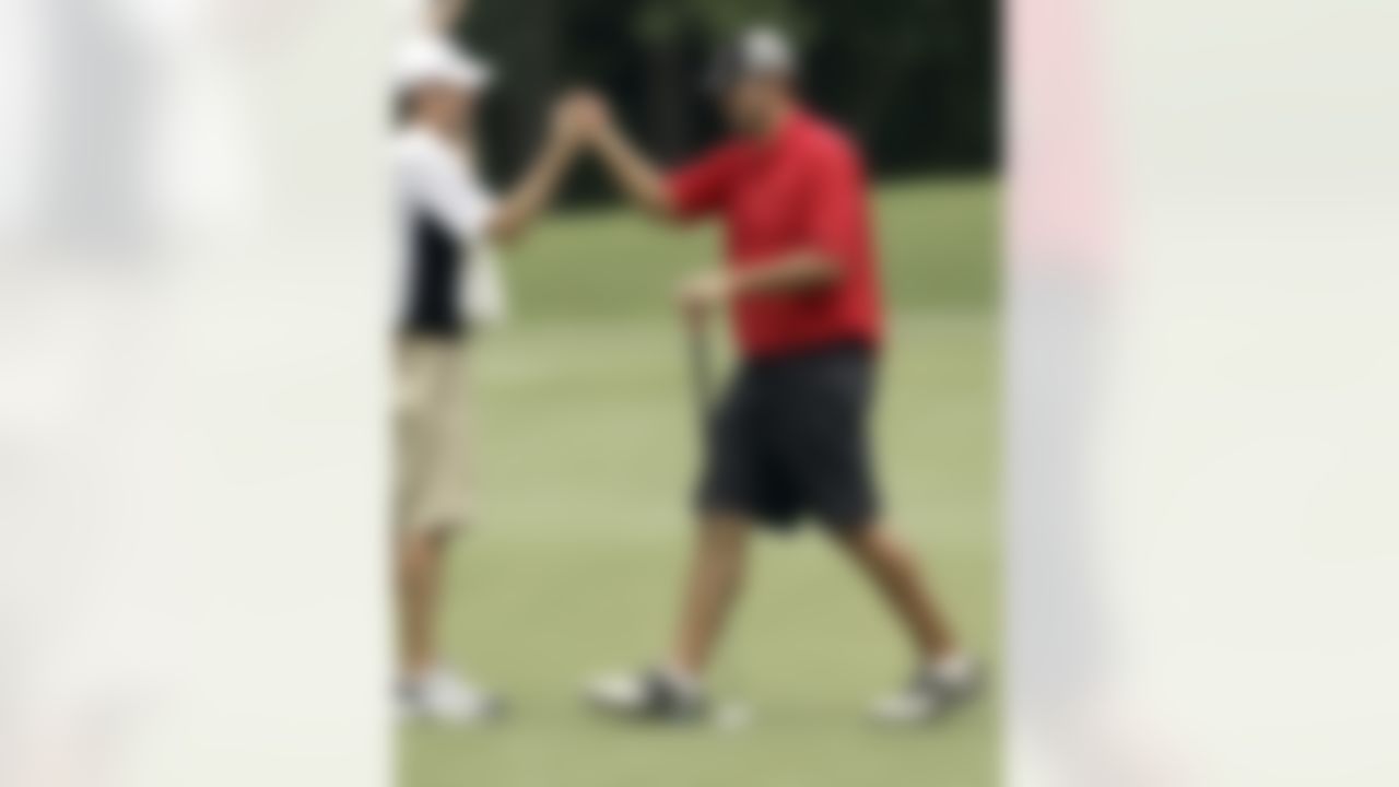 Dallas Cowboys quarterback Tony Romo, right, celebrates his birdie on the 14th hole with his caddy Bob Swanson, left, during sectional qualifying for the 2010 U.S. Open golf tournament Monday, June 7, 2010 at the Club at Carlton Woods in The Woodlands, Texas. The U.S. Open will be played June 14-20 at Pebble Beach Golf Links in Pebble Beach, Calif. (AP Photo/David J. Phillip)