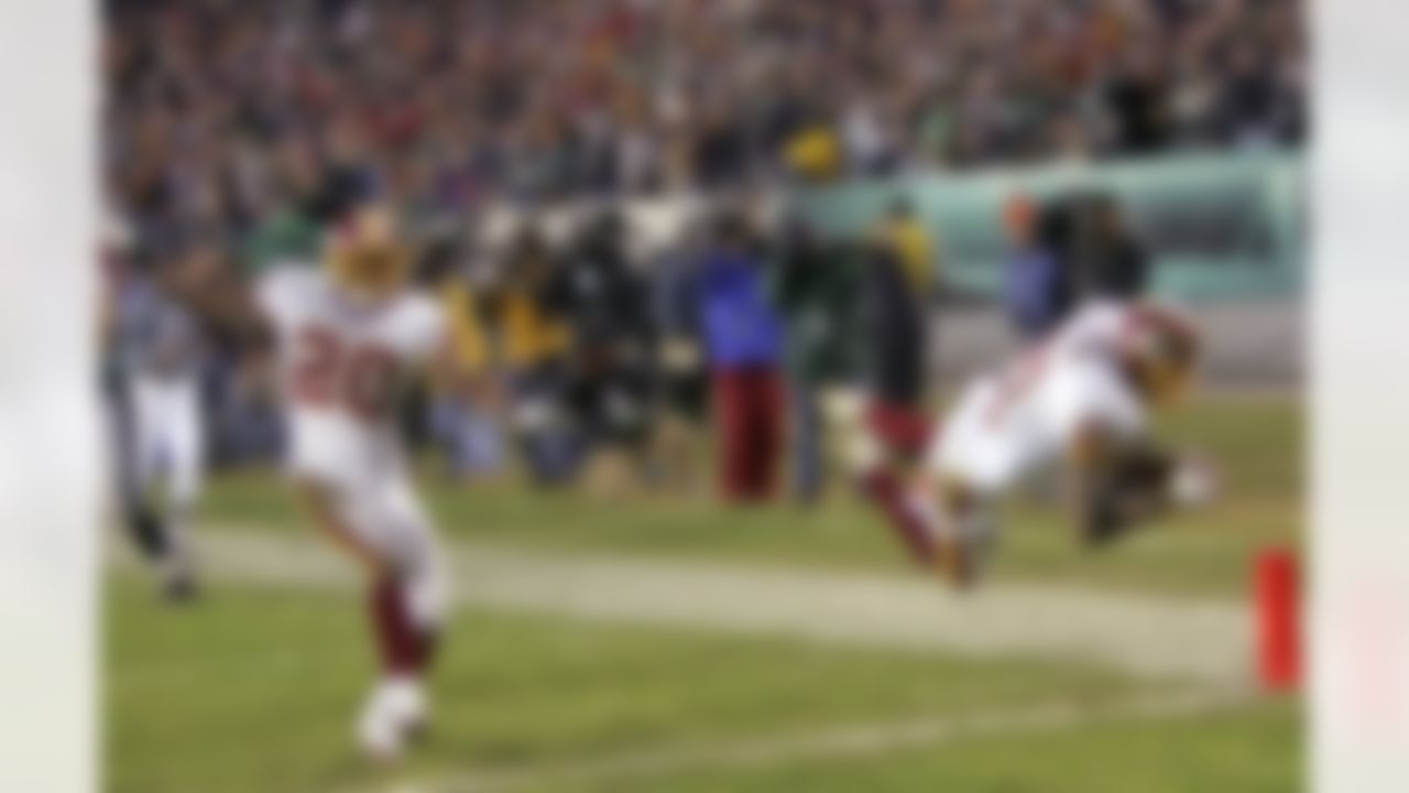 Washington Redskins safety Sean Taylor (21) leaps for a touchdown after his 39-yard fumble-return against the Philadelphia Eagles in the fourth quarter of their NFL football game Sunday, Jan. 1, 2006, in Philadelphia. At left is safety Pierson Prioleau (20). The Redskins won, 31-20. (AP Photo/Tom Mihalek)