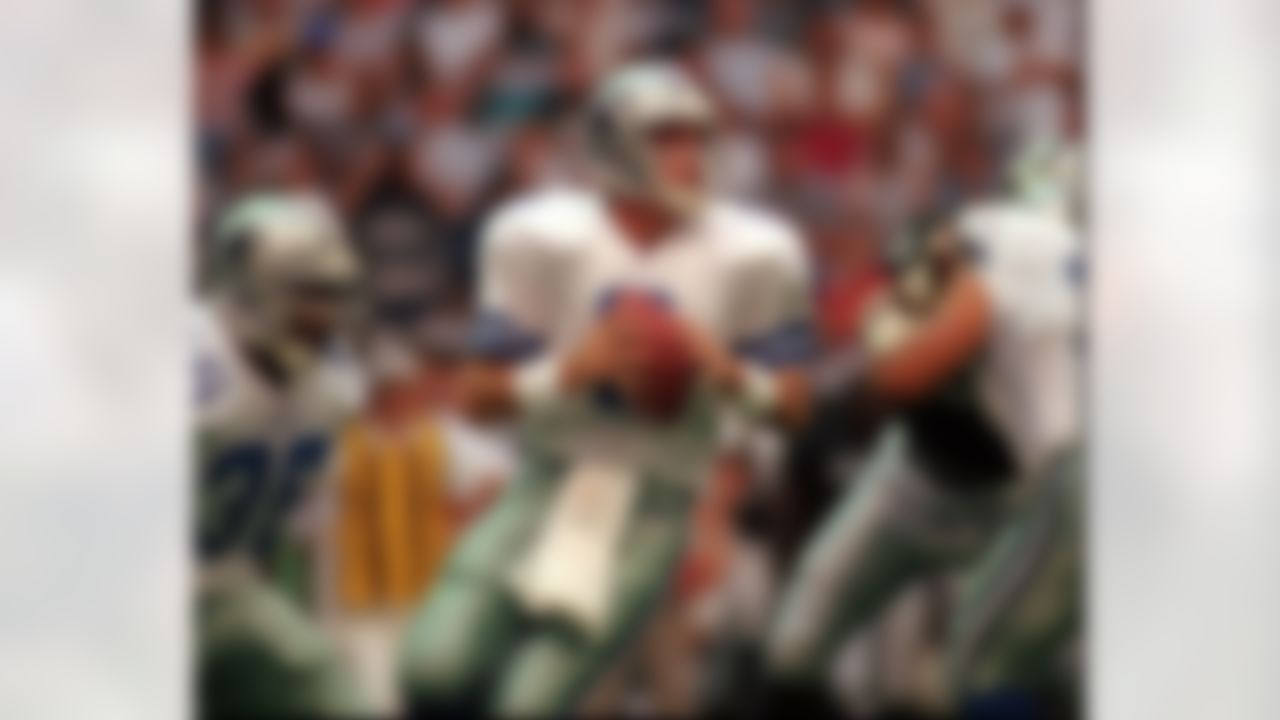 Dallas Cowboys quarterback Troy Aikman (8) drops back to pass during the preseason game aginst the Oakland Raiders in Irving, Texas, July 27, 1996. Aikman has on his hands a hurting team that has to be held together until Michael Irvin's suspension ends, tight end Jay Novacek can fight through a painful back injury, and Emmitt Smith and Mark Tuinei can run on 100 percent healthy knees. (AP Photo/Eric Gay)