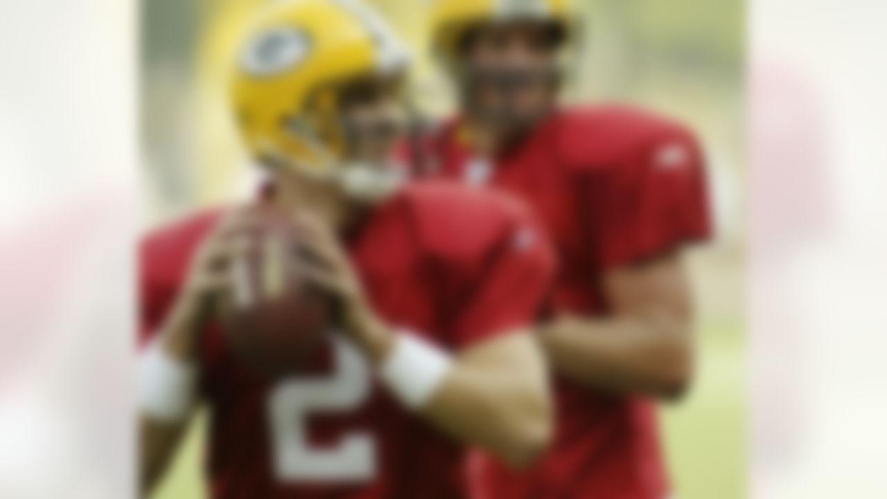 Green Bay Packers' newly acquired Tim Couch, left and seasoned veteran Brett Favre, right take some early morning passing drills on the opening day of training camp for the 2004 season Monday Aug. 2, 2004 Green Bay, Wis. (AP Photo/Darren Hauck)