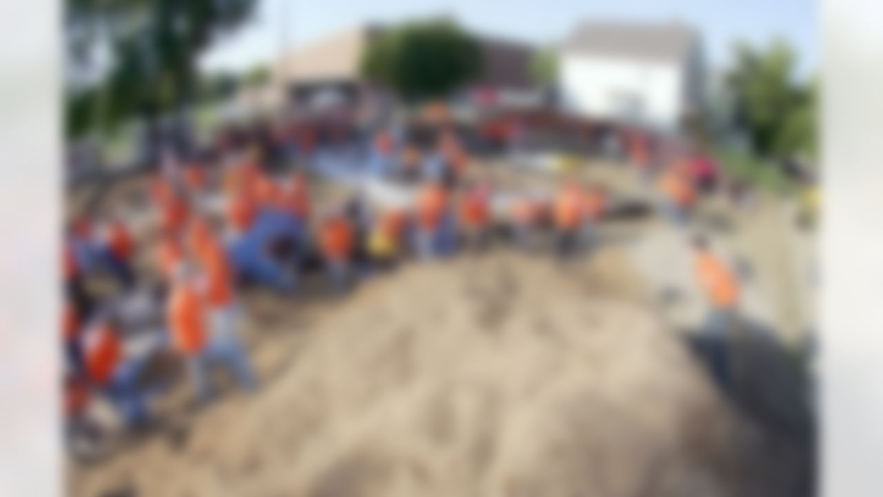 The Home Depot associates help move 145 cubic yards of mulch. (Photo by Alan Marler/CIA Stock Photography, Inc.)