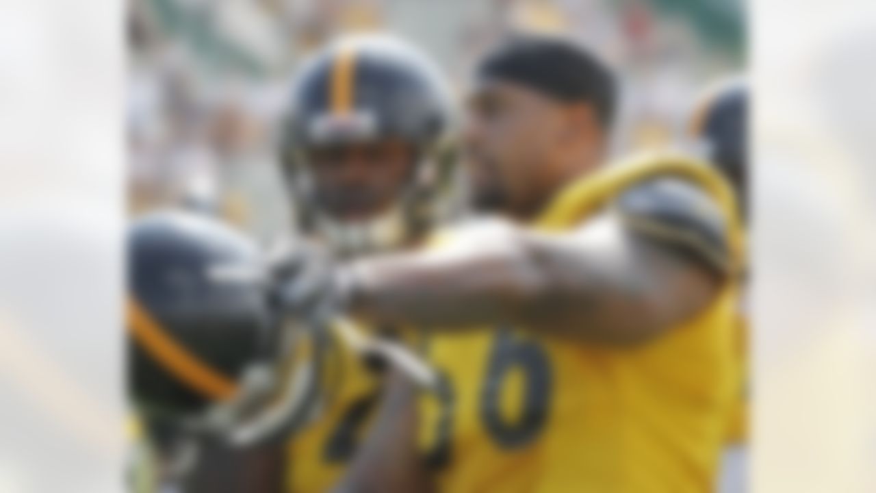 Pittsburgh Steelers linebacker LaMarr Woodley, right, gives Will Johnson some pointers during a blocking drlll in practice at the NFL football training camp in Latrobe, Pa. on Saturday, July 28, 2012 . (AP Photo/Keith Srakocic)