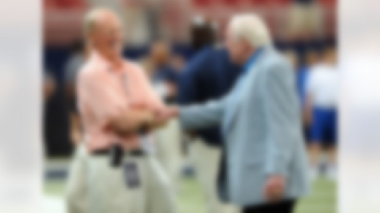 Former NFL coaches Jim Hanifan, right, and Marty Schottenheimer talk before the start of an NFL football game between the Arizona Cardinals and the St. Louis Rams Sunday, Sept. 8, 2013, in St. Louis. (AP Photo/L.G. Patterson)