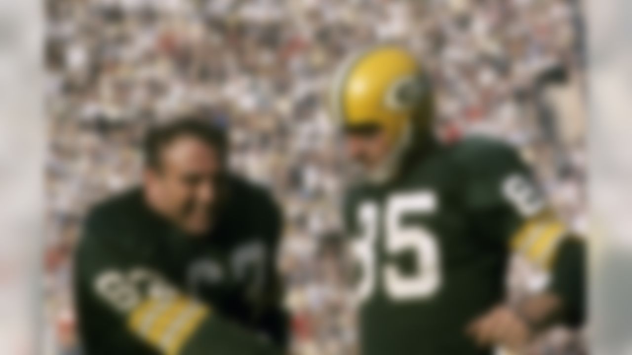 Green Bay Packers guard Fuzzy Thurston (63) congratulates wide receiver Max McGee (85) after a touchdown catch agains the Kansas City Chiefs during Super Bowl I at the Los Angeles Memorial Coliseum on January 15, 1967. (National Football League)