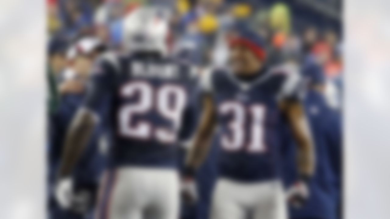 New England Patriots running back LeGarrette Blount (29) receives congratulations from Aqib Talib (31) at the bench after his touchdown in the second quarter of an NFL football game against the Buffalo Bills Sunday, Dec. 29, 2013, in Foxborough, Mass. (AP Photo/Elise Amendola)