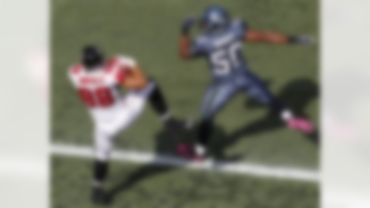 Atlanta Falcons Tony Gonzalez catches a pass to score a touchdown under pressure from Seattle Seahawks K.J. Wright in the first half of a NFL football game, Sunday, Oct. 2, 2011, in Seattle. (AP Photo/Elaine Thompson)