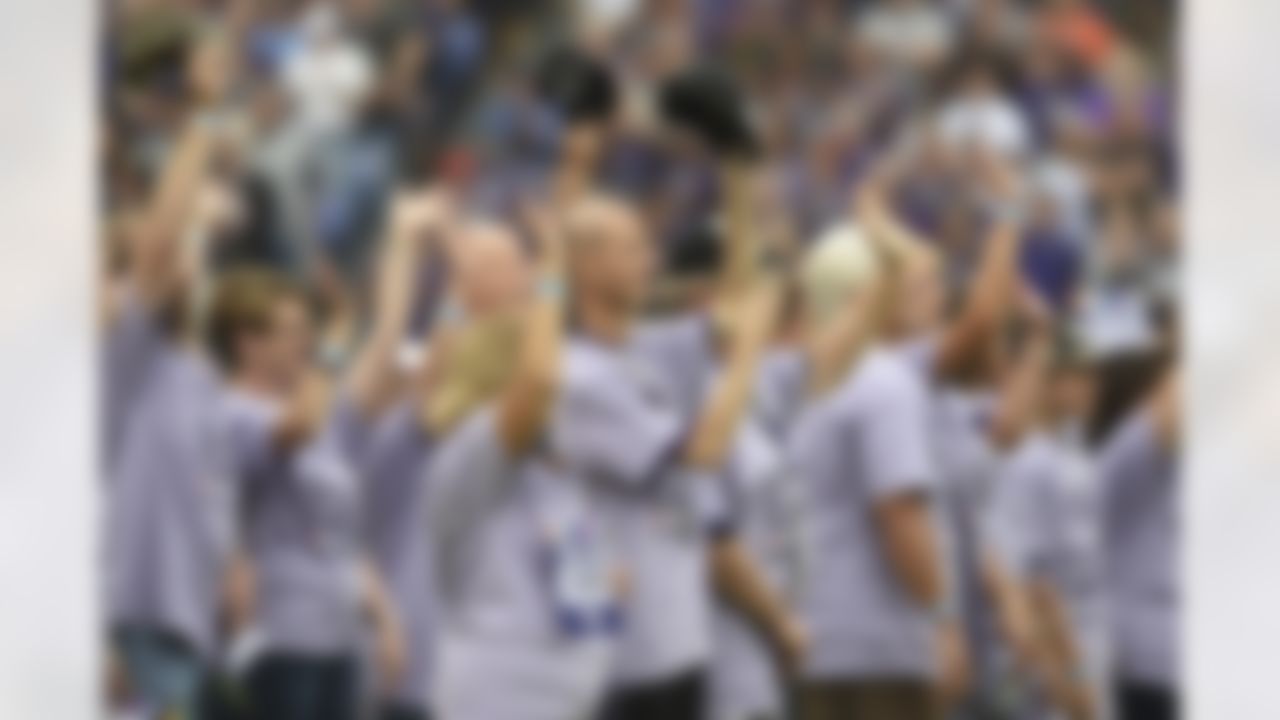 Cancer survivors stand on the field�before an NFL football game between the Baltimore Ravens and the Chicago Bears, Sunday, Oct. 15, 2017, in Baltimore.