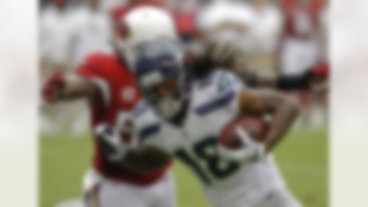 Seattle Seahawks wide receiver Sidney Rice (18) is tackled by Arizona Cardinals linebacker Reggie Walker during the first half of their NFL football game, Sunday, Sept. 9, 2012, in Glendale, Ariz. (AP Photo/Ross D. Franklin)
