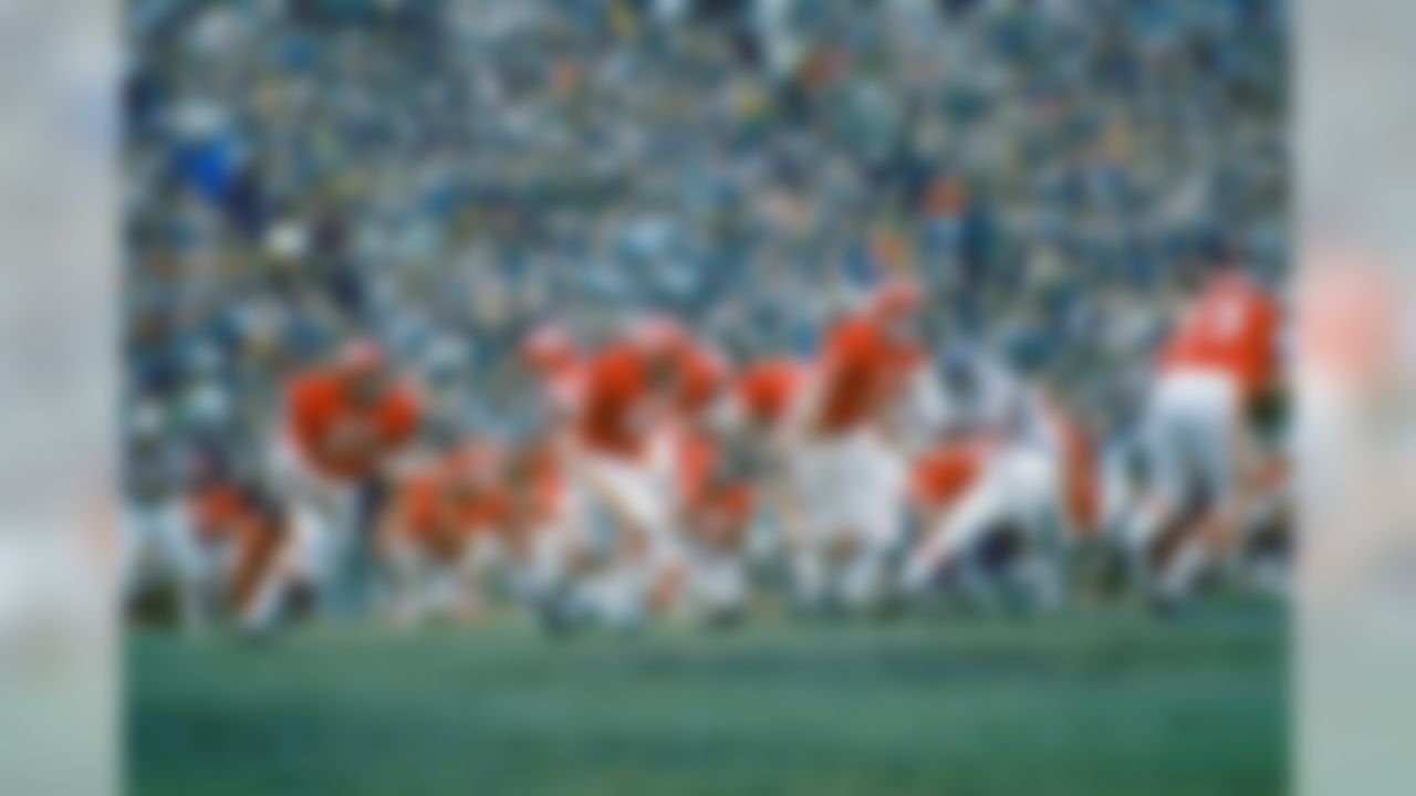 Kansas City Chiefs quarterback Len Dawson prepares to handoff to running back Mike Garrett (21) as running back Robert Holmes (45) and guard Ed Budde (71) lead the play during the Super Bowl in New Orleans on Jan. 11, 1970. (Associated Press)