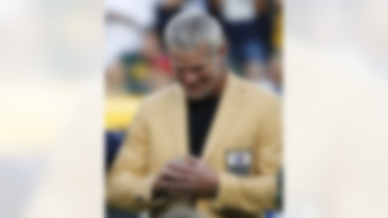 Former Green Bay Packers quarterback Brett Favre looks at his Hall of Fame ring during a halftime ceremony of an NFL football game against the Dallas Cowboys Sunday, Oct. 16, 2016, in Green Bay, Wis. (AP Photo/Mike Roemer)