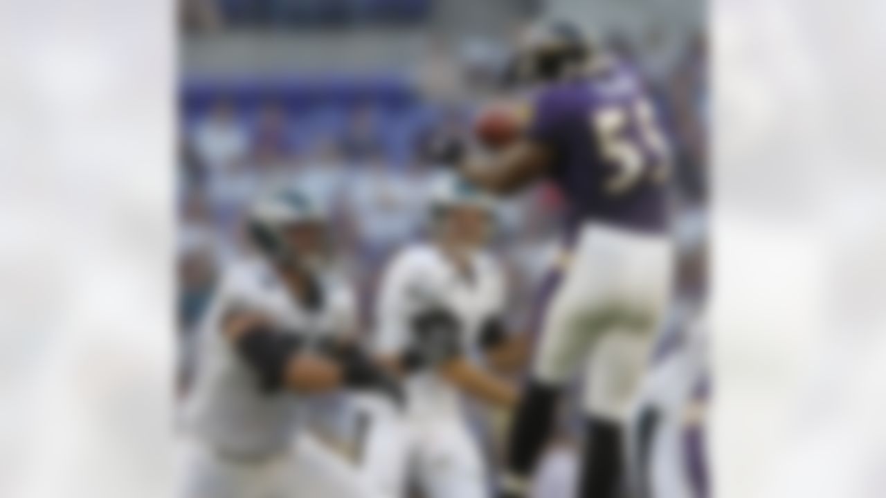 Philadelphia Eagles quarterback A.J. Feeley has his pass blocked by Baltimore Ravens linebacker Terrell Suggs (55) during the first quarter of a preseason football game Monday, Aug. 13, 2007, in Baltimore. Also pictured is Eagles' Victor Abiamiri, left.(AP Photo/Gail Burton)