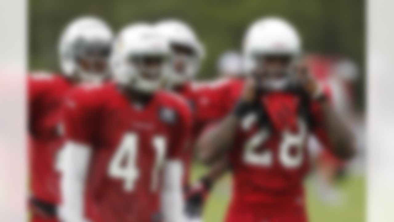 Arizona Cardinals' Greg Toler (28) gets ready for defensive back drills as teammates Larry Parker (41), Jamell Fleming, far left, and James Nixon await their turn during NFL football training camp at Northern Arizona University, Thursday, July 26, 2012, in Flagstaff, Ariz. (AP Photo/Ross D. Franklin)