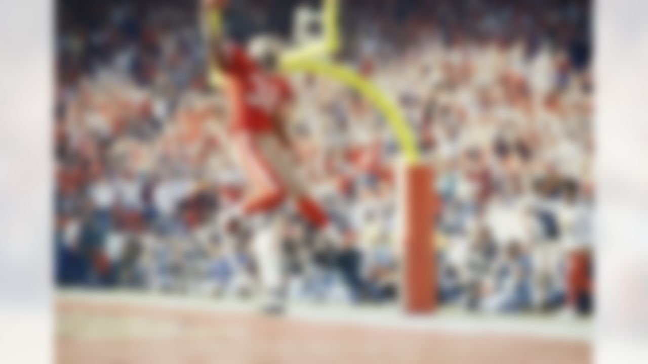 San Francisco 49ers' running back Ricky Watters celebrates in the end zone, Saturday, Jan. 15, 1994, after scoring one of his five playoff record touchdowns against the New York Giants. The Niners defeated the Giants, 44-3, in the NFC divisional playoffs at Candlestick Park in San Francisco. (AP Photo/Eric Risberg)