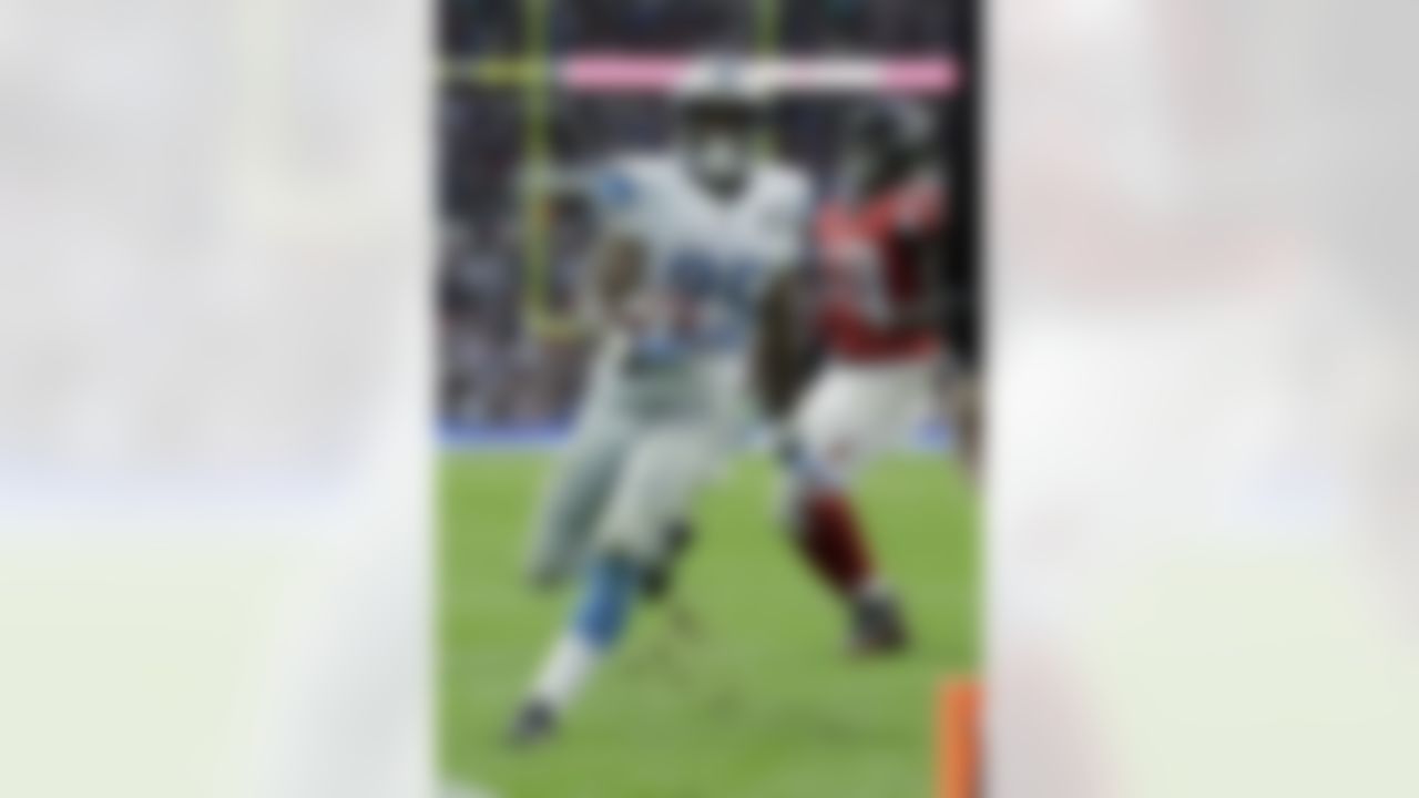 Detroit Lions running back Theo Riddick (25) runs to the end zone for a touchdown after receiving a pass thrown by quarterback Matthew Stafford (9) in the second half of the NFL football game against the Atlanta Falcons at Wembley Stadium, London, Sunday, Oct. 26, 2014. (AP Photo/Matt Dunham)