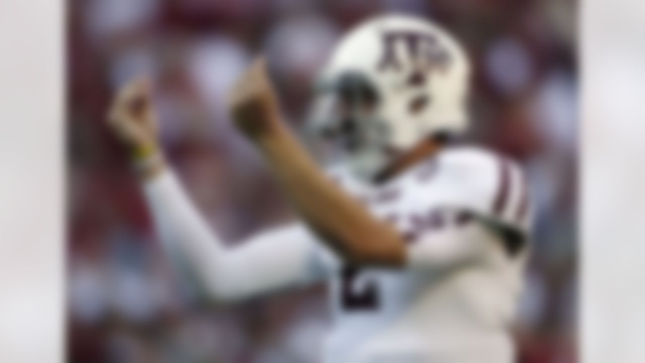 Texas A&M quarterback Johnny Manziel (2) reacts after the Aggies scored their third touchdown of the first quarter against Alabama during the first half of an NCAA college football game at Bryant-Denny Stadium in Tuscaloosa, Ala., Saturday, Nov. 10, 2012. (AP Photo/Dave Martin)