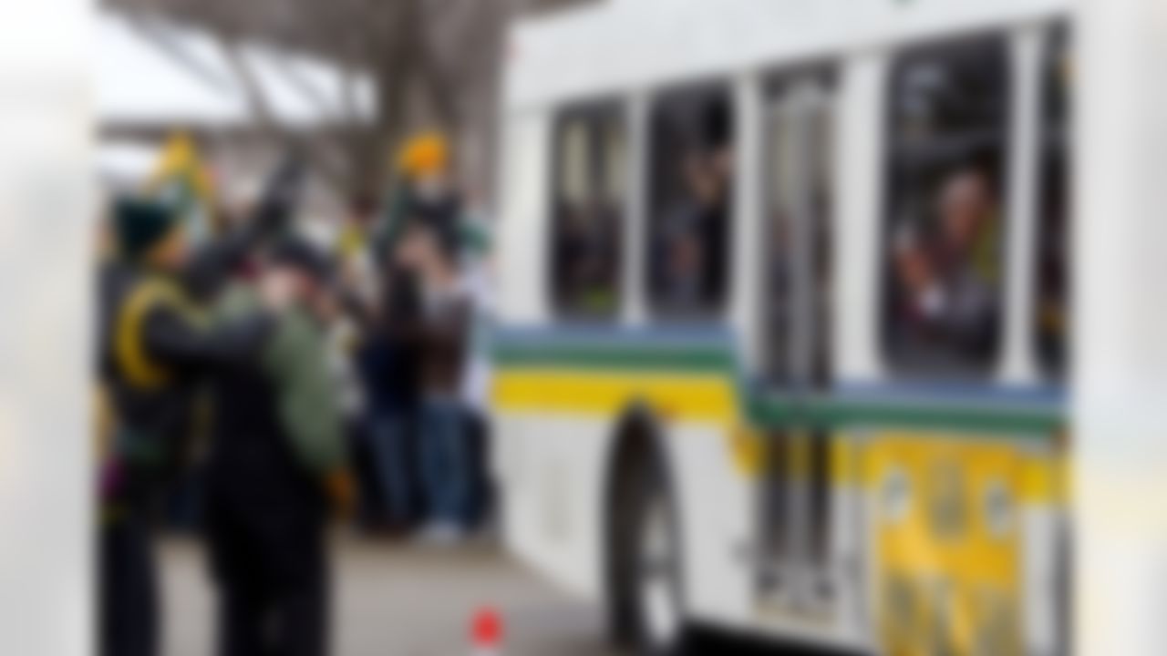 Green Bay Packers wide receiver Donald Driver takes pictures out of the window of a bus as the NFL football team returns Monday, Feb. 7, 2011, to Lambeau Field in Green Bay, Wis. The Packers defeated the Pittsburgh Steelers 31-25 in Super Bowl XLV on Sunday. (AP Photo/Mike Roemer)