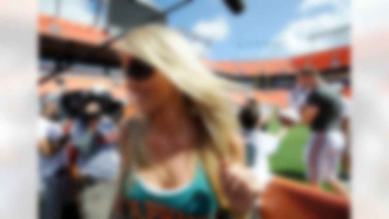 Aug. 4, 2012; Miami, FL, USA; Lauren Ufer (left) the wife of Miami Dolphins quarterback Ryan Tannehill (right) leaves field after a teams scrimmage at Sun Life Stadium. Mandatory Credit: Steve Mitchell-US PRESSWIRE