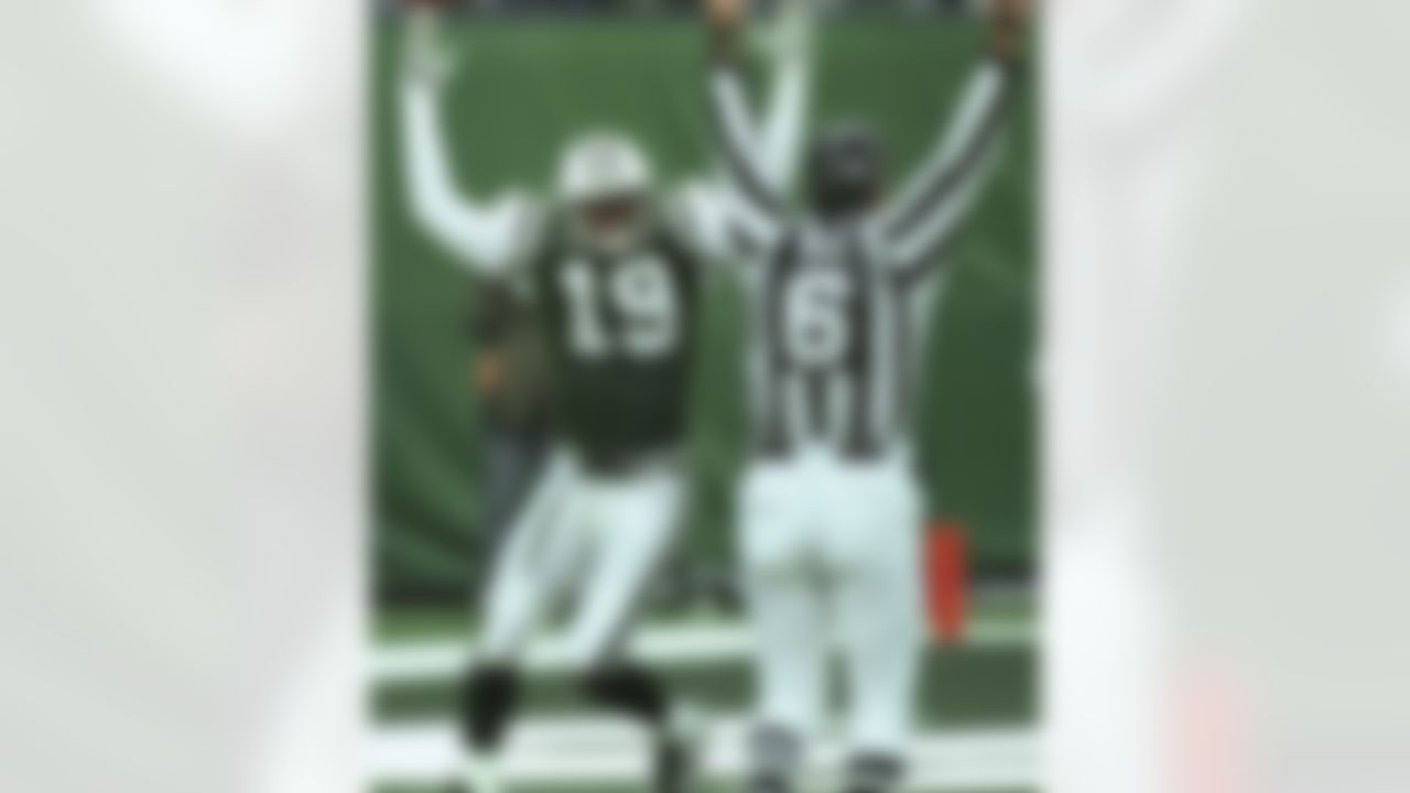 New York Jets wide receiver Keyshawn Johnson (19) joins back judge Kirk Dornan (6) signaling touchdown during the fourth quarter Sunday, Nov. 7, 1999, at Giants Stadium in East Rutherford, N.J. Johnson scored a 43-yard touchdown giving the Jets a 12-7 win over the Arizona Cardinals.