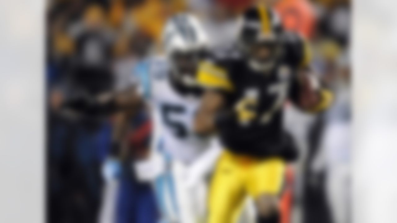 Pittsburgh Steelers wide receiver Mike Wallace (17) scores a touchdown as Carolina Panthers linebacker Nic Harris (59) tries to make a tackle during the second quarter of an NFL football game, Thursday, Dec. 23, 2010 in Pittsburgh. (AP Photo/Don Wright)