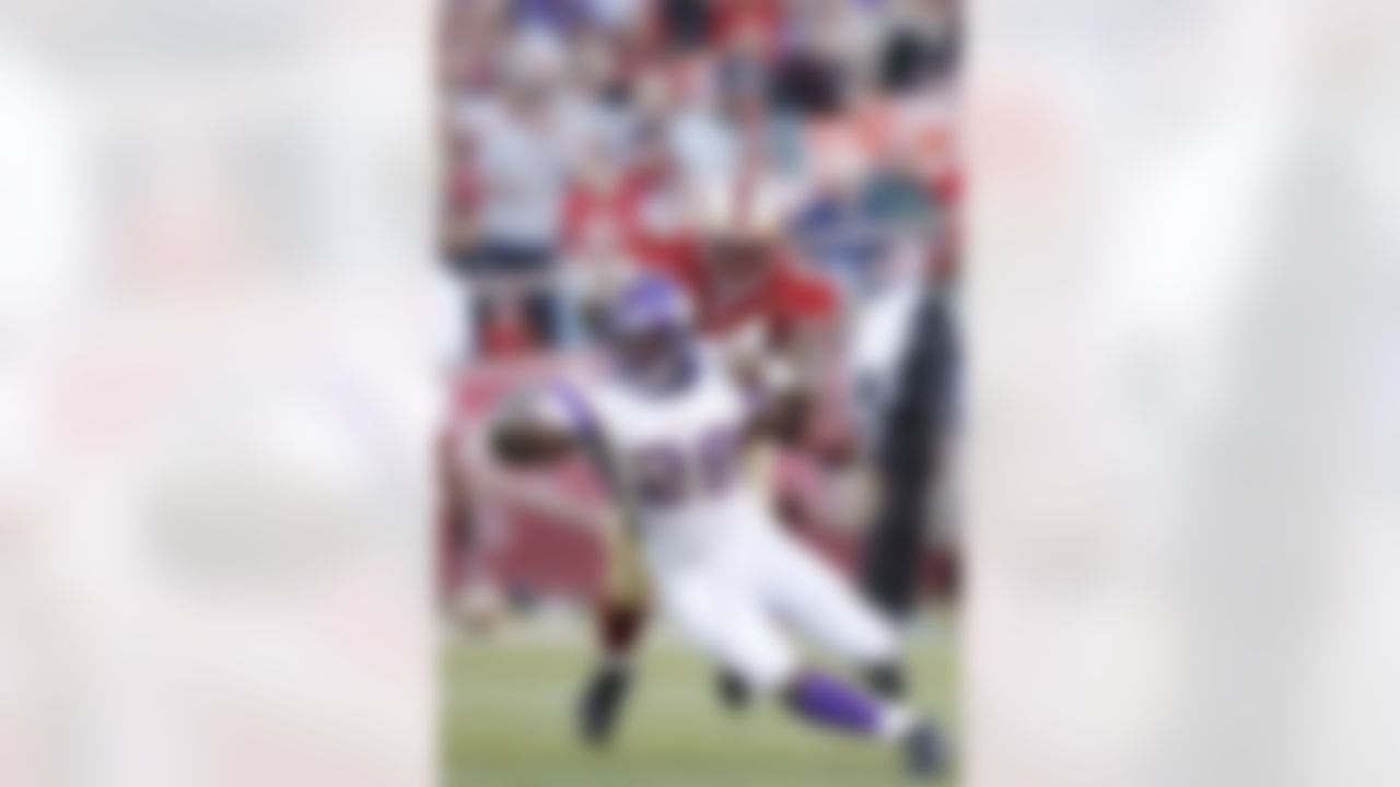 SAN FRANCISCO - DECEMBER 9: Running back Chester Taylor #29 of the Minnesota Vikings is tackled by defensive lineman Marques Douglas #94 of the San Francisco 49ers during a game on December 9, 2007 at Monster Park in San Francisco, California. (Photo by Greg Trott/Getty Images)