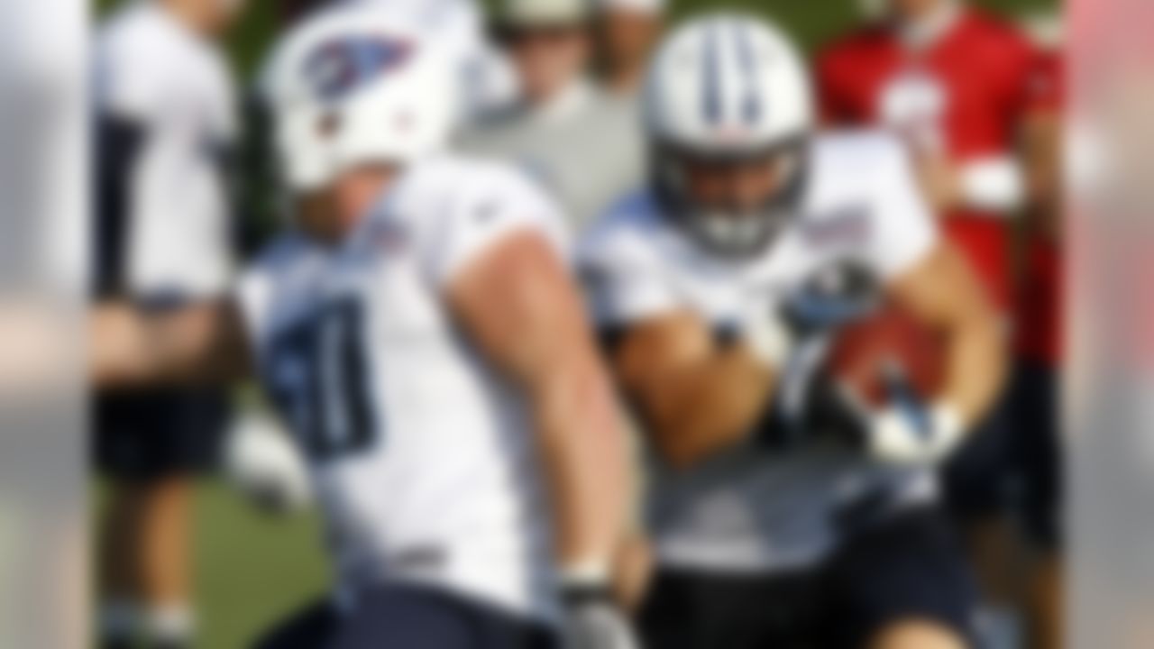 Tennessee Titans fullback Collin Mooney, right, follows the block of center Kevin Matthews during NFL football camp at Titans' headquarters Saturday, July 28, 2012 Nashville, Tenn. (AP Photo/Wade Payne)