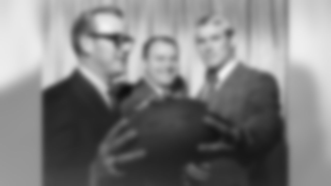 Pittsburgh Steelers' No. 1 draft choice Terry Bradshaw, right, poses with Steelers coach Chuck Noll, center, and his father, William M. Bradshaw, left, in Pittsburgh. John Elway, Troy Aikman and Peyton Manning were far more dazzling. Earl Campbell was far more feared. Yet teams draft players they think will help them win championships. Bradshaw, selected No. 1 overall, guided the Steelers to four Super Bowl titles and was the MVP in two of those championship games. (AP Photo/Harry Cabluck, File)