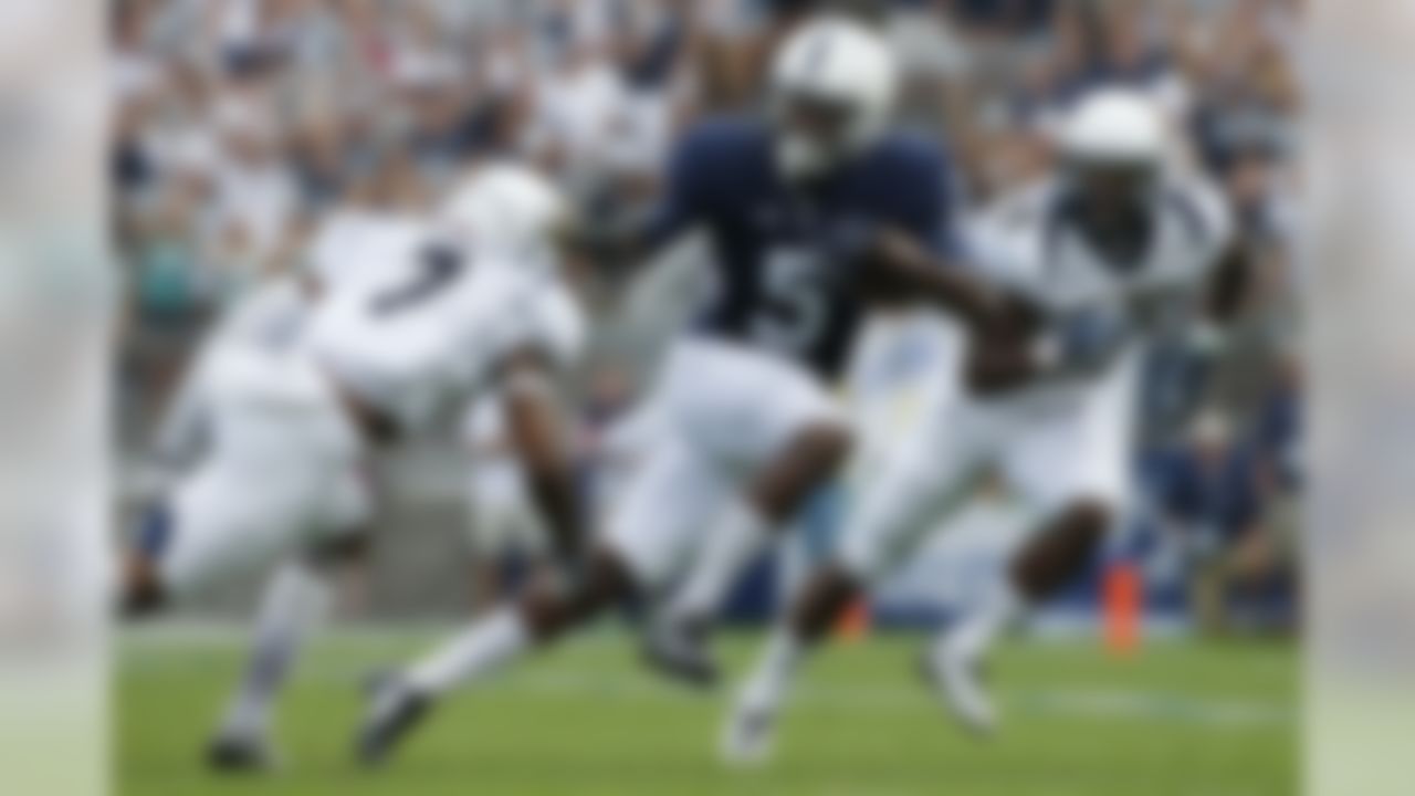 Penn State wide receiver DaeSean Hamilton (5) runs between Akron safety Devonte Morgan (7)  and cornerback Bryce Cheek (29) after taking a pass from quarterback Christian Hackenberg for a first down during the first quarter of an NCAA college football game in State College, Pa., Saturday, Sept. 6, 2014. (AP Photo/Gene J. Puskar)