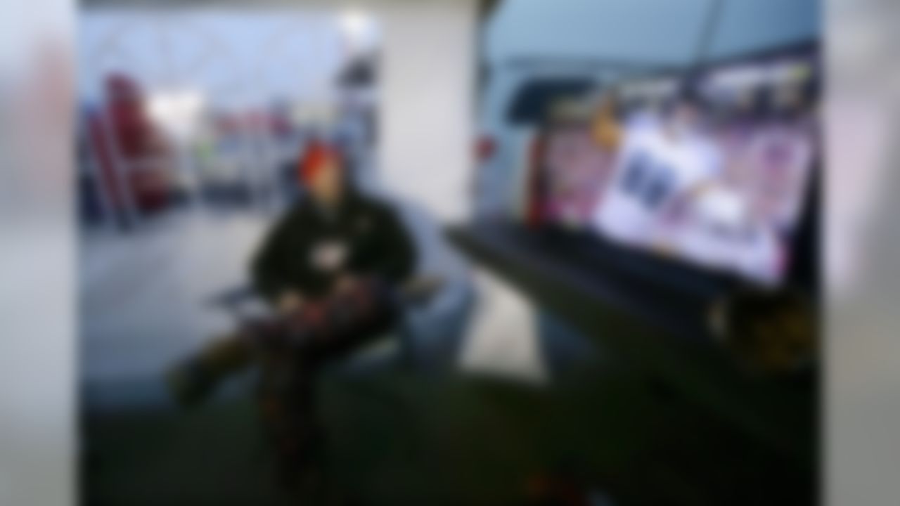Mike Reed, of Andover, Mass., watches a football game on a television in his tent while tailgating in the parking lot of Gillette Stadium before an NFL divisional playoff football game between the New England Patriots and the Houston Texans, Saturday, Jan. 14, 2017, in Foxborough, Mass. (AP Photo/Elise Amendola)