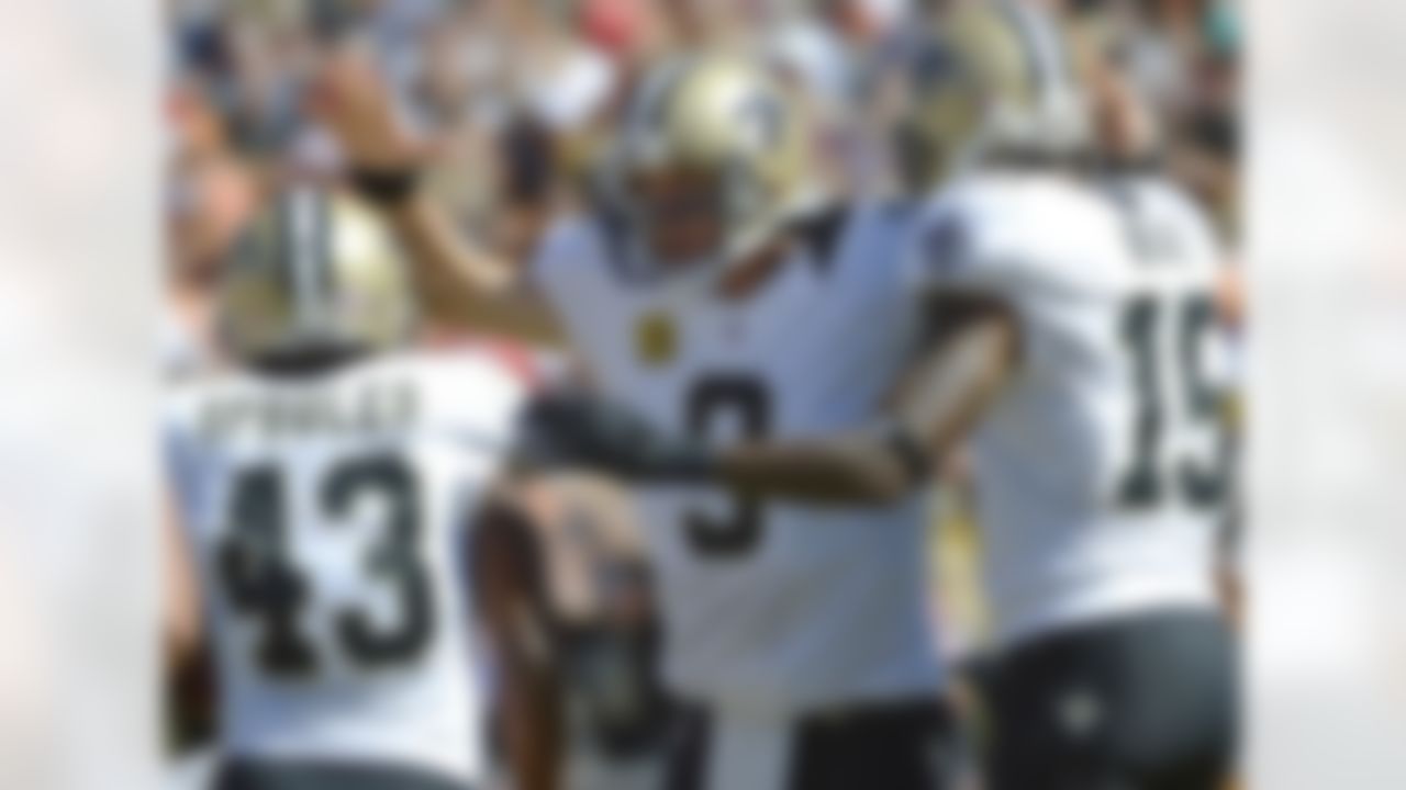 New Orleans Saints quarterback Drew Brees, center, celebrates with running back Darren Sproles (43) and wide receiver Courtney Roby (15) after Sproles scored on a 9-yard touchdown run during the first half of an NFL football game against the Tampa Bay Buccaneers in Tampa, Fla., Sunday, Oct. 21, 2012. (AP Photo/Phelan M. Ebenhack)