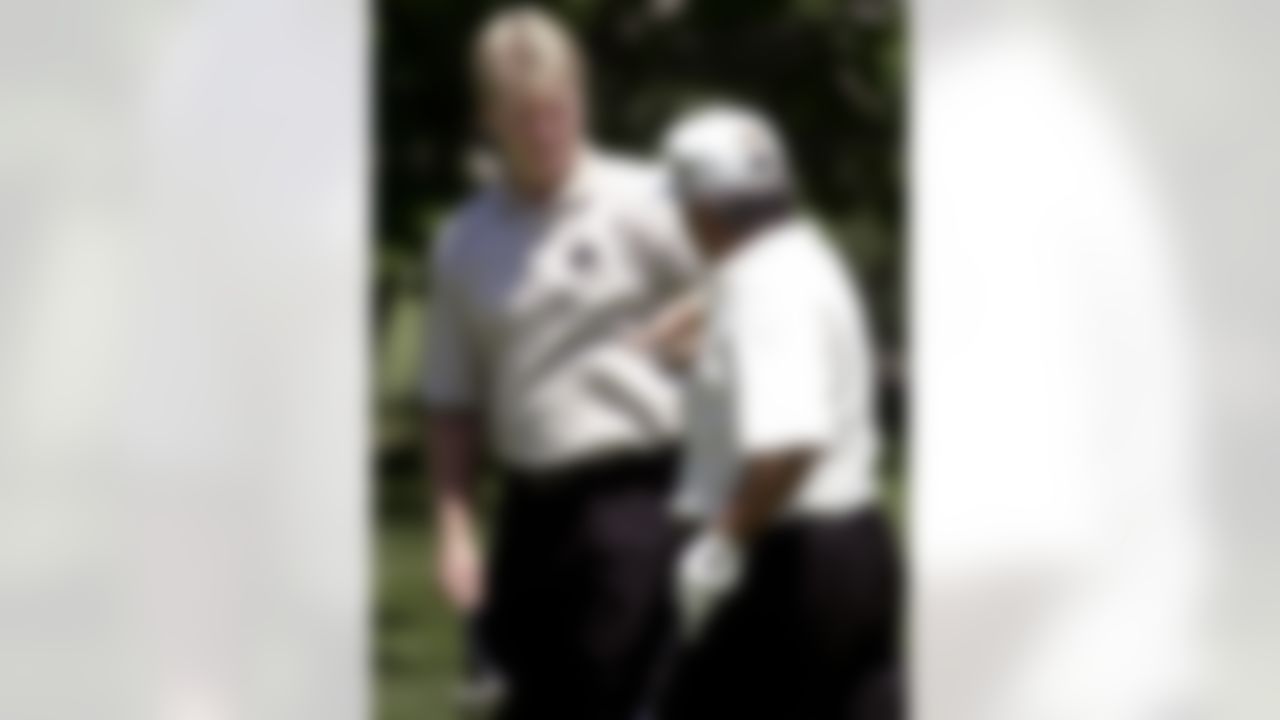 Former New York Giants quarterback Phil Simms, left, slaps hands with Senior PGA golfer Lee Trevino after Simms sank a 20-foot putt on the 10th hole during the NFL Golf Classic at the Upper Montclair Country Club in Clifton, N.J., Thursday, June 7, 2001. Trevino won last year's Senior PGA NFL Classic, which is to start Friday. (AP Photo/Mike Derer)
