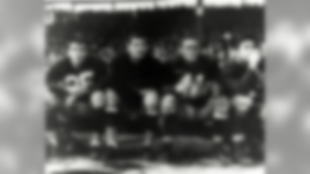 Washington Redskins Hall of Fame quarterback Sammy Baugh looks on with teammates from the bench in the 1940 NFL Championship where the Redkskins were defeated 73 to 0 by the Chicago Bears at Griffith Stadium in Washington D.C. (Pro Football Hall Of Fame)