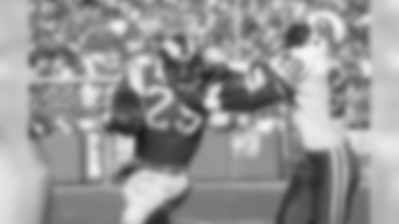 Los Angeles Rams running back Eric Dickerson (29) tries to fend off Buffalo Bills cornerback Mario Clark as each entwine their fingers in the other's face mask during the first quarter at Anaheim Stadium, Sunday, Nov. 27, 1983, Anaheim, Calif. No penalty was charged. Dickerson gained 12 yard and a first down on the running play. (AP Photo/Doug Pizac)