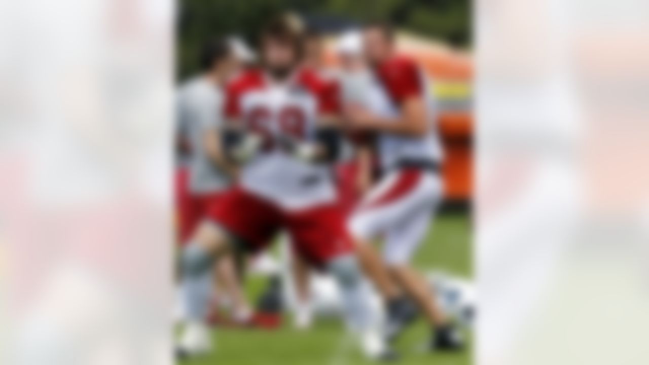 Arizona Cardinals' Kevin Kolb, right, drops back after taking a snap from Adam Snyder (68) during NFL football training camp at Northern Arizona University on Thursday, July 26, 2012, in Flagstaff, Ariz. (AP Photo/Ross D. Franklin)