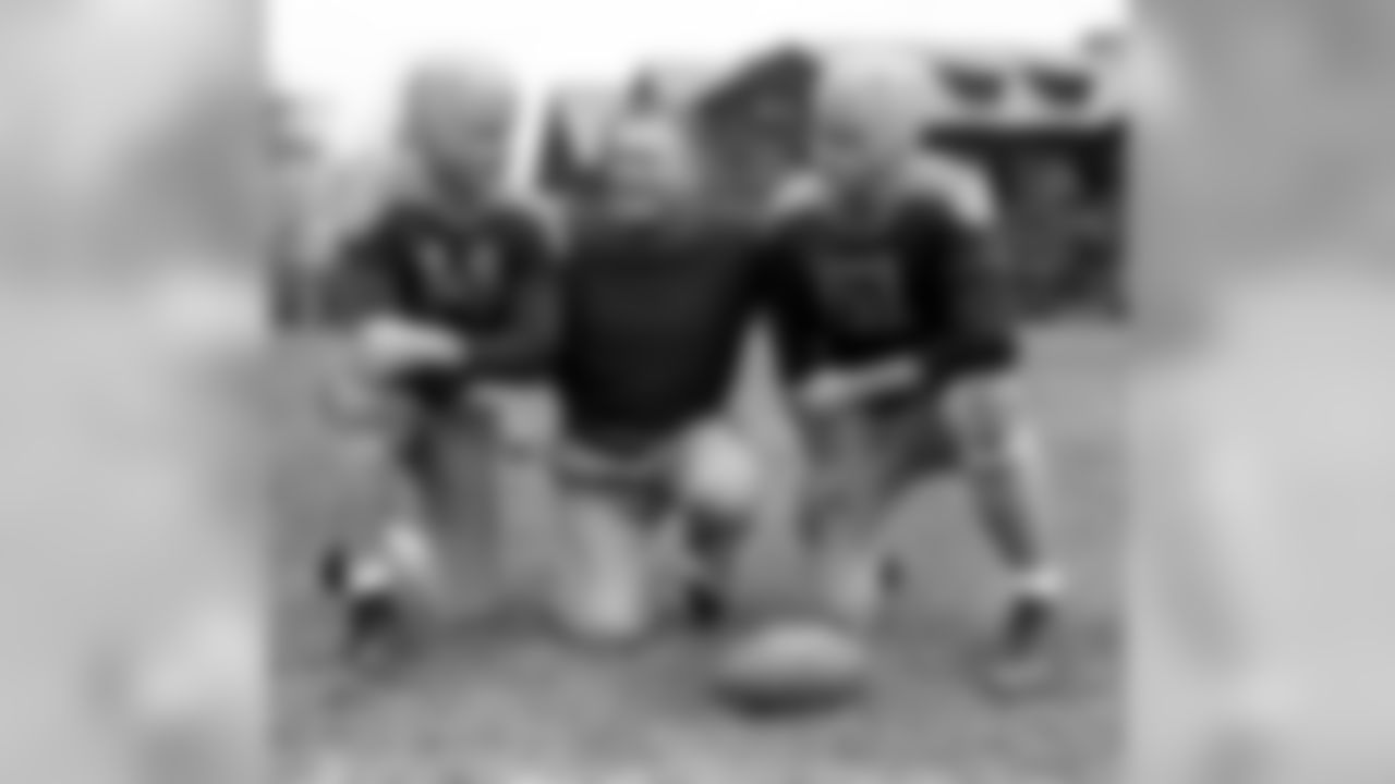 Green Bay Packers' Don Hutson, left, and Irv Comp, right, received instructions from coach Curly Lambeau during training at Bear Mountain, N.Y., Nov. 15, 1944. (AP Photo/John Lindsay)