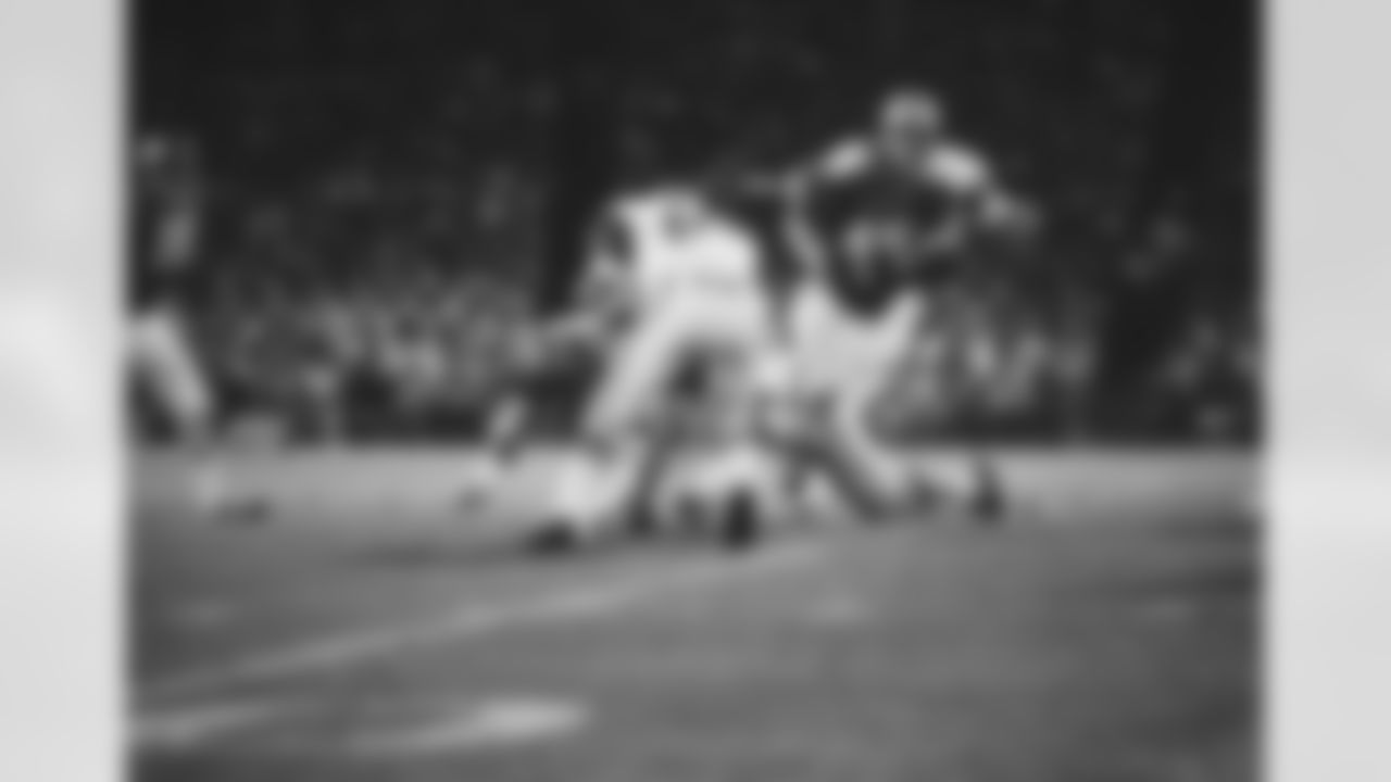 Kansas City Chiefs running back Bobby Holmes (45) gets through for a first-down gain in the exhibition game with the New York Jets in Kansas City, on August 31, 1971. Blocker Ed Budde holds back Jets Gerry Philbin (81), as Mark Lomas (rear) closes in on Holmes. The Chiefs won the game 21-16. (AP Photo/William Streater)