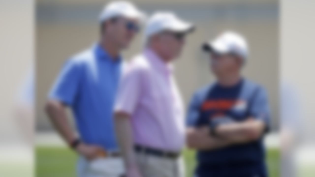 Former NFL quarterbacks Peyton Manning, left, and father Archie, center, chat with Denver Broncos head trainer Steve Antonopulos as the Broncos work out at the team's NFL football training facility Wednesday, June 5, 2019, in Englewood, Colo.