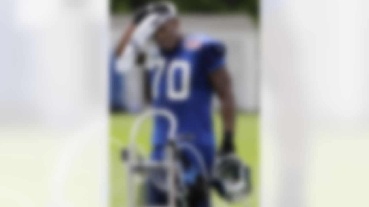 New York Giants defensive end Craig Marshall (70) wipes his head with a towel during a workout on a sunny day at the New York Giants NFL football training camp in Albany, N.Y., Sunday, July 29, 2012. (AP Photo/Kathy Willens)