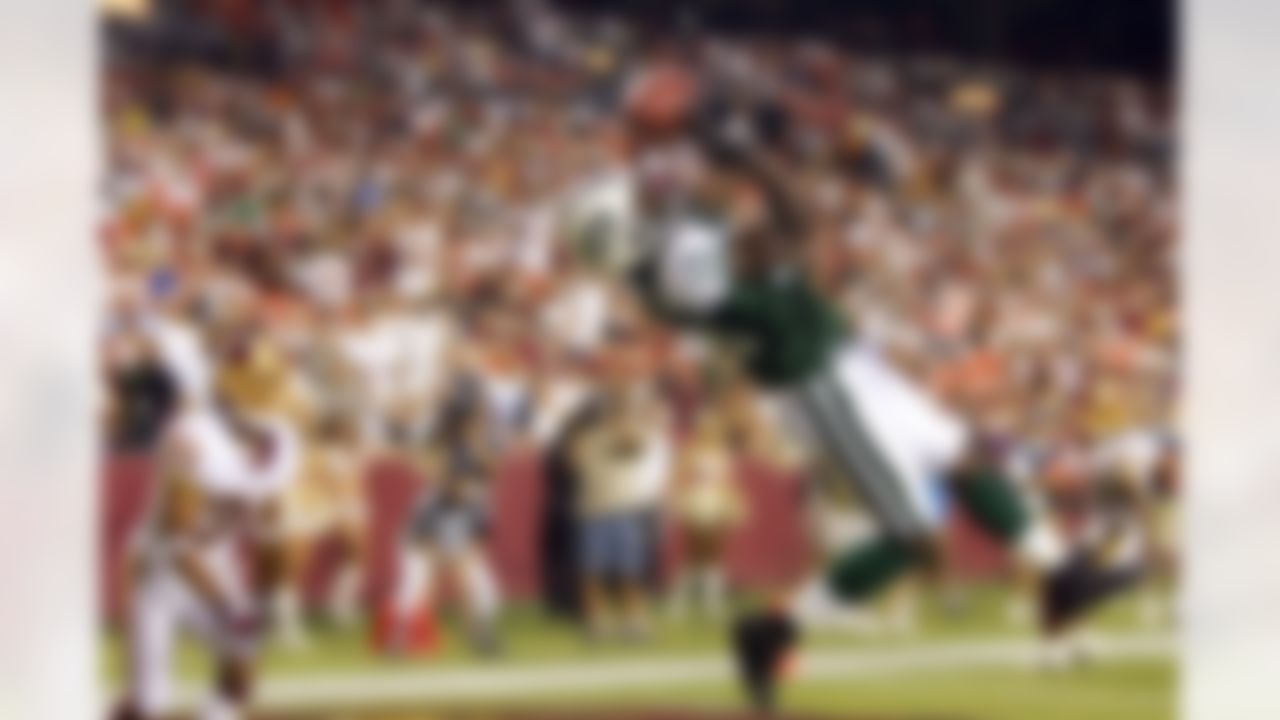 Jets wide receiver Reggie Newhouse leaps into the air to catch a touchdown pass in front of Washington's John Eubanks during an NFL game at FedEx Field in Landover, MD on Saturday, August 19, 2006. The Jets defeated the Redskins 27-14. Photo by Rafael Suanes/Getty Images.