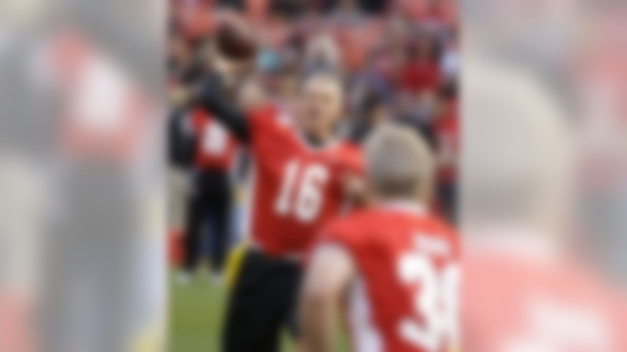 Hall of Fame quarterback Joe Montana, left, passes the ball to running back Bill Ring, right, during the "Legends of Candlestick" flag football game Saturday, July 12, 2014, in San Francisco. The game between former San Francisco 49er greats and a team of former NFL stars captained by Hall of Famer Dan Marino is the final one to be played at Candlestick Park.  The park, which opened in 1960 and was also the home of the San Francisco Giants baseball team until 1999, is slated for demolition in the next year. (Eric Risberg/Associated Press)